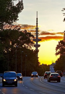 Cars on the Kennedy Bridge in front of the Heinrich Hertz Tower at sunset