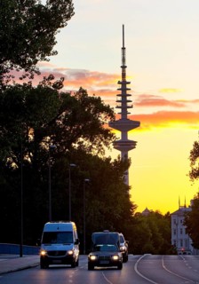 Cars on the Kennedy Bridge in front of the Heinrich Hertz Tower at sunset