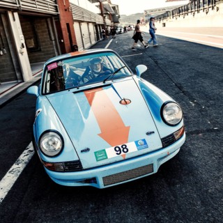 60s style shot of historic racing car sports car classic car Porsche 911 RS in pit lane Pit Lane of race track