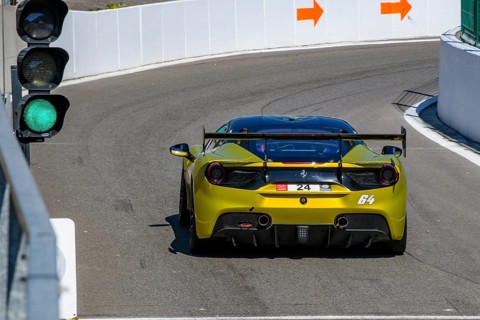 Racing car Sports car Ferrari 488 Challenge has green light to exit pit lane Pit Lane on racetrack