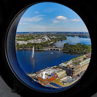 City view of the Inner Alster Lake through the porthole windows in the spire of the Hauptkirche St. Petri