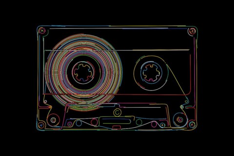 Happy cassette in colors over black background