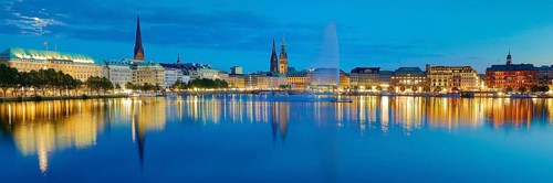 Inner Alster with Alsterfontaine and city skyline in the evening