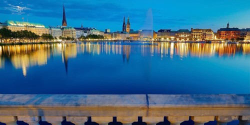 Inner Alster with Alsterfontaine and city skyline in the evening
