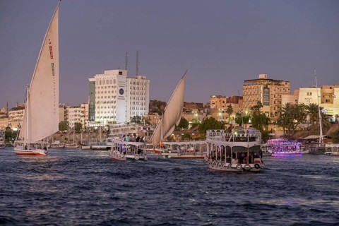 Sailing ships and excursion boats on the evening Nile at Aswan