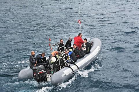 Divers travel to their dive site in an inflatable boat