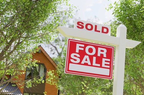 Sold for sale real estate sign in front of property