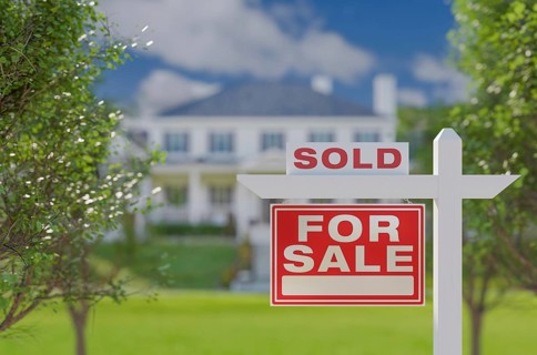 Sold for sale real estate sign in front of property