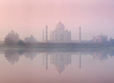 Taj Mahal on sunrise sunset reflection in Yamuna river panorama in fog