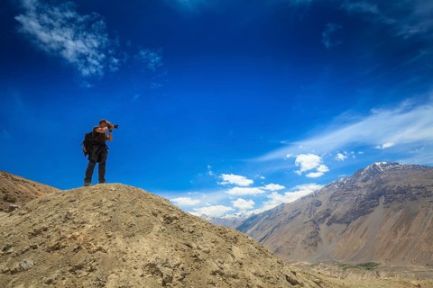 Photographer taking photos in Himalayas mountains. Spiti valley