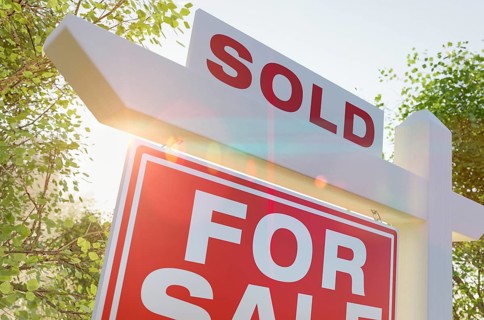 Sold for sale real estate sign in front of property