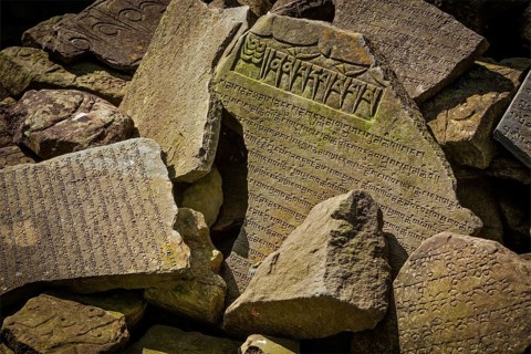 Buddhist prayer mantras on stones in Tibetan Buddhism temple
