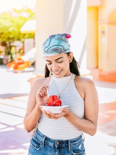 Young woman holding a cup of shaved ice on the street. Concept of a girl with a Nicaraguan raspado. Portrait of smiling girl holding shaved ice in the street. ICE SHAVING from Nagarote
