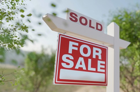 Sold for sale real estate sign in front of property