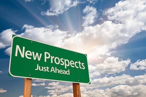 New prospects green road sign over sunny dramatic clouds and sky