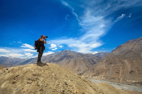 Photographer taking photos in Himalayas mountains. Spiti valley
