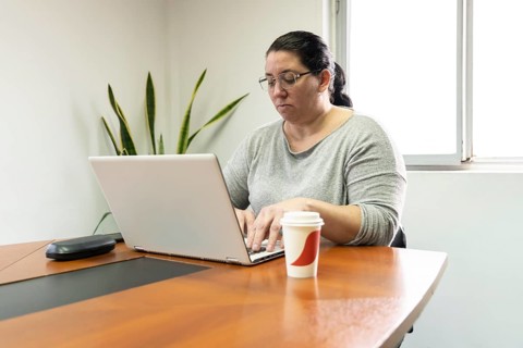 Mature business woman sitting at the head of the table in an office meeting room