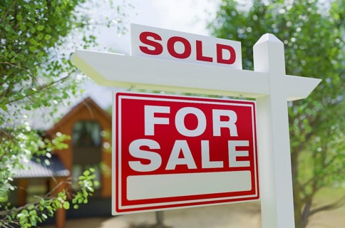 Sold for sale real estate sign in front of property