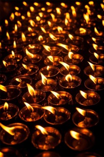 Burning candles in Tibetan Buddhist temple. Himachal Pradesh