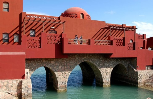 Bridge with buildings over lagoon