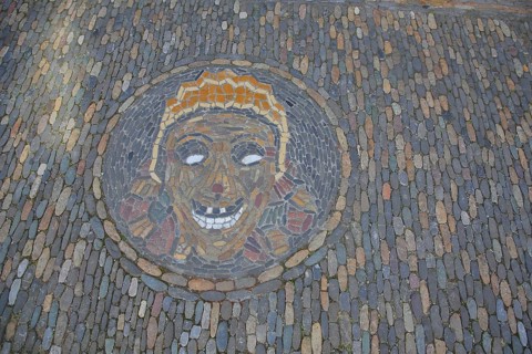 Round floor mosaic for Halloween with head and face made of colourful stones in Freiburg