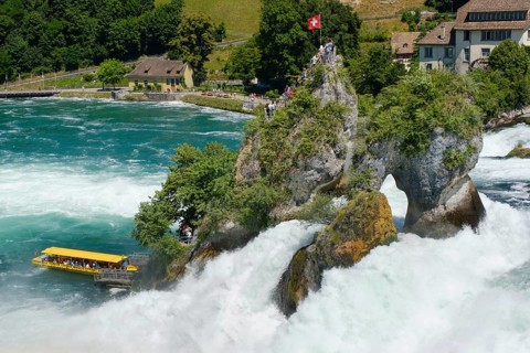 Tourist boat at the jetty of the viewing rock in the Rhine Falls