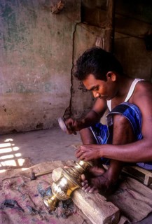 An artisan working on brass lamp at Nachiyar Koil near Thanjavur Tanjore