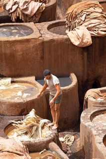 Workers dyeing leather