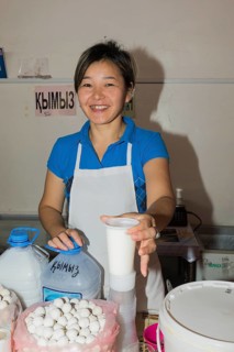 Kazakh woman selling kumis made from mare's milk