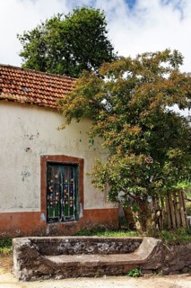 Old house with bench made of stone