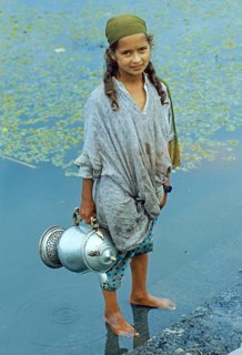 Kashmiri girl standing in a watercraft