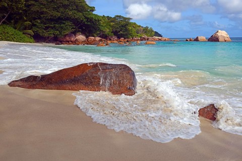 Beach and rocks of Anse Lazio in the evening