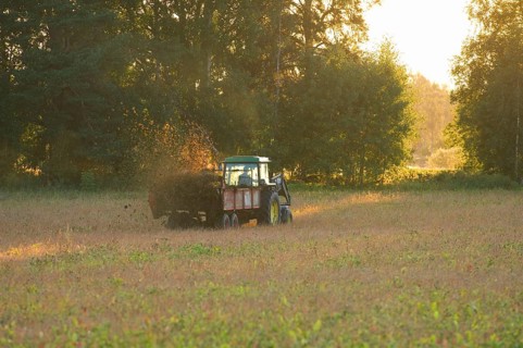 John Deere tractor pulling manure spreader