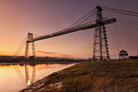 View of the transporter bridge over the river at dusk