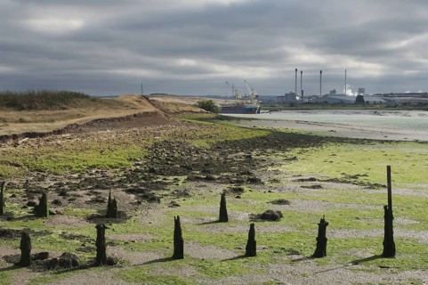 Estuary at low tide with mudflats and breakwaters