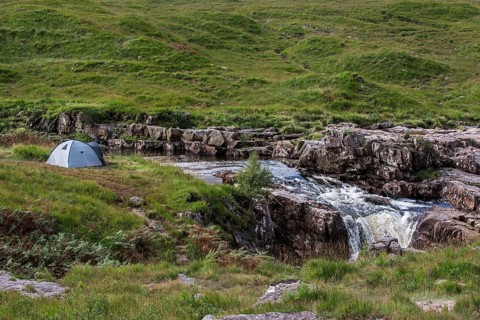 Wild camping with light dome tent along the River Etive in Glen Etive near Glencoe in the Scottish Highlands