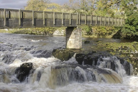 Bridge and cascades over limestone cliffs