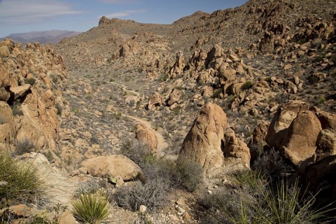 Valley and path with eroded igneous rocks and remains of laccoliths