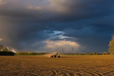 Tractor drilling farmland