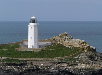 View of lighthouse on coastal island