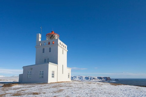 Dyrholaey lighthouse near Vik i Myrdal on the central south coast of Iceland in the snow in winter
