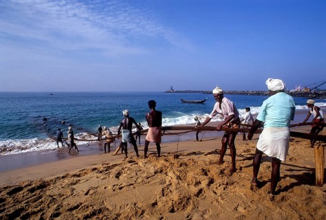 Fishermen hauling the fishing nets in Vizhinjam near Thiruvananthapuram