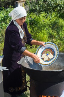 Kazakh woman preparing traditional local tandyr bread