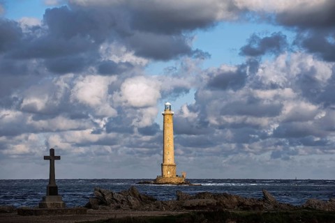 Lighthouse at Cap de La Hague and monument in honour of the French submarine crew Vendemiaire