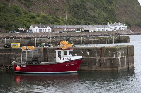 Lobster fishing boat at harbour of fishing village Burnmouth