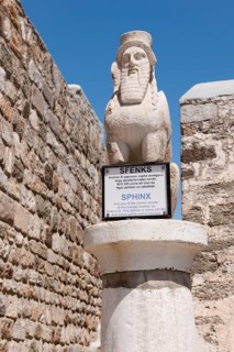 Sphinx with beard and wings on pillar