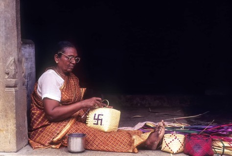 Old woman weaving palm leaf baskets in Chettinad