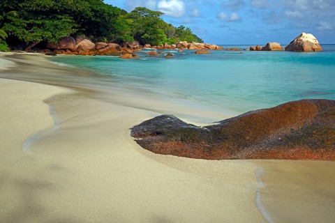 Beach and rocks of Anse Lazio in the evening