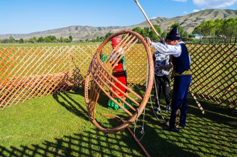 Kazakh men building a yurt