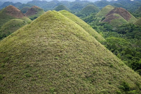 Cone-shaped karst hills of grass-covered limestone